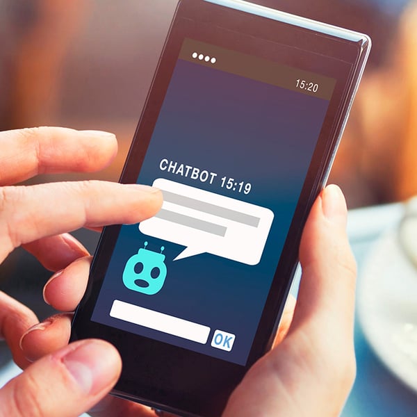 squared_hands_holding_phone_with_chatbot