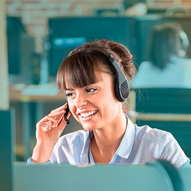 squared_woman_holding_headset_mic_at_desk