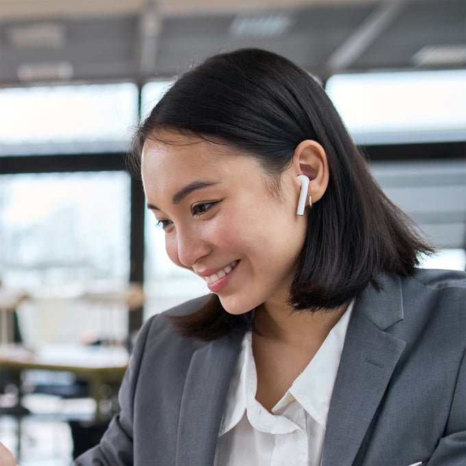 squared_women_with_earplugs_at_laptop