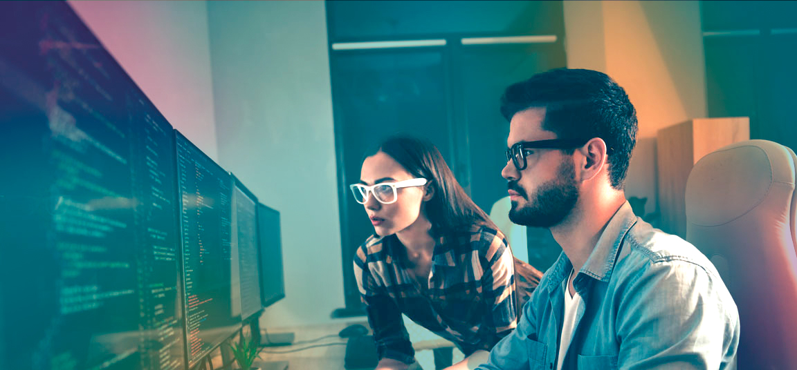 man_and_women_at_pc_with_code