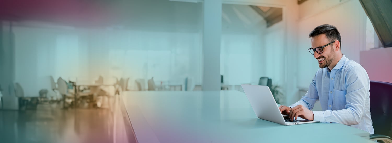 man_looking_atcomputer_happy_bigofficespace_header