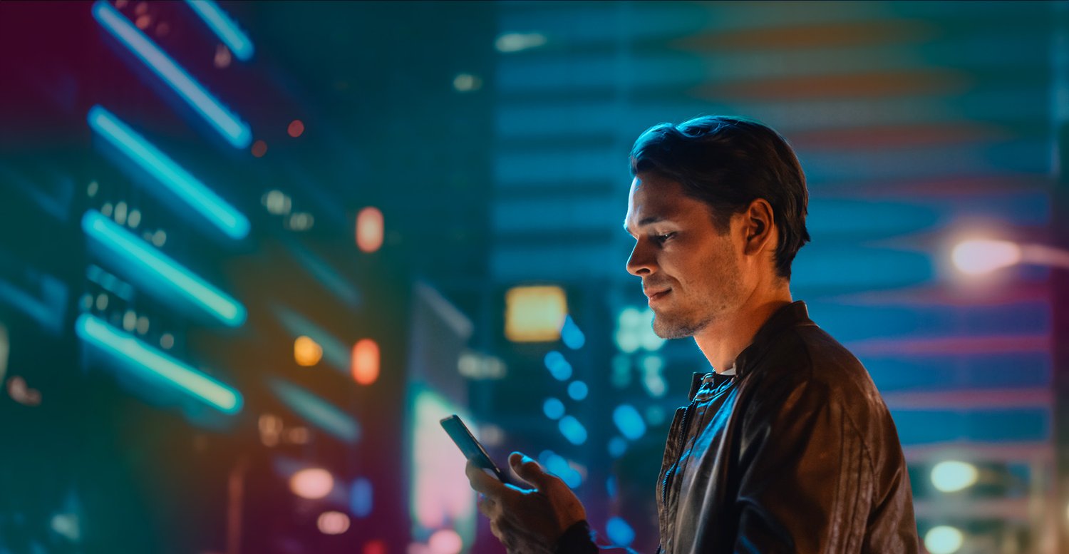 man_outside_with_phone_at_night