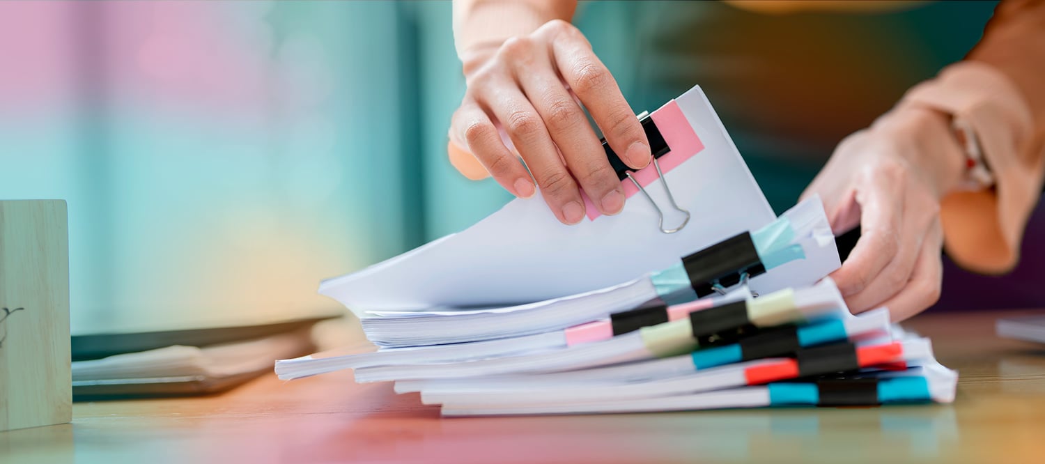 person_with_a_stack_of_papers