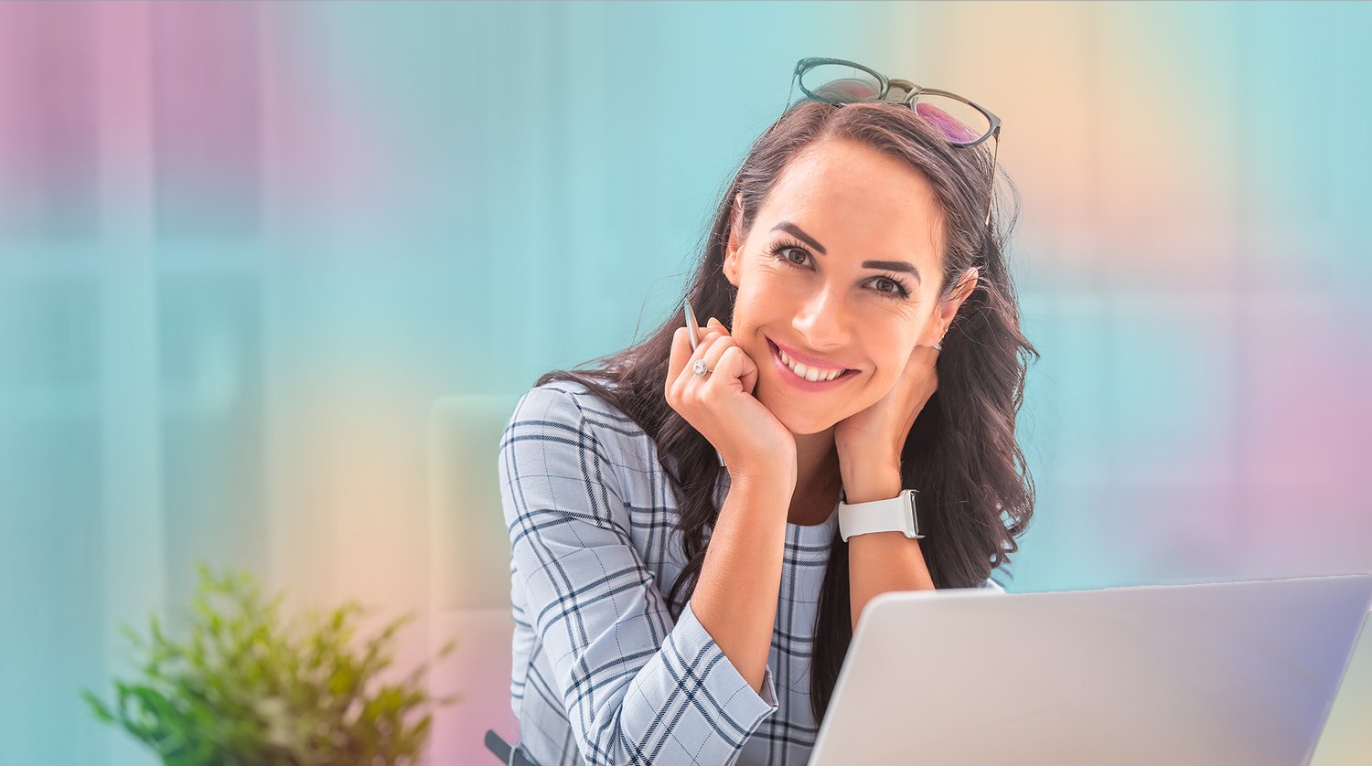 smiling_woman_looking_out_with_laptop