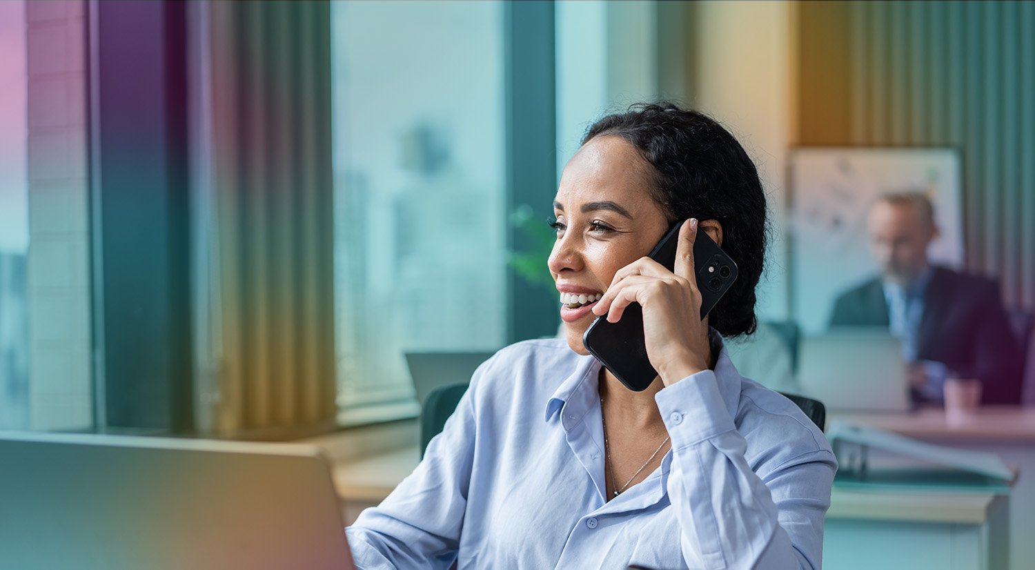 smiling_woman_on_phone_at_laptop