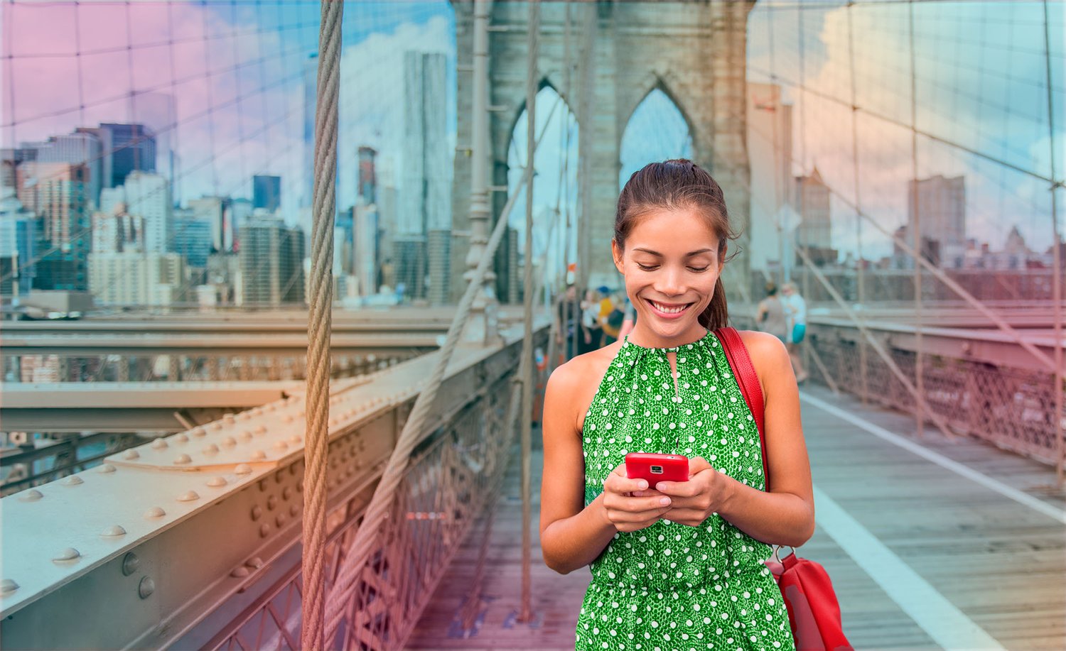 smiling_woman_with_phone_on_bridge