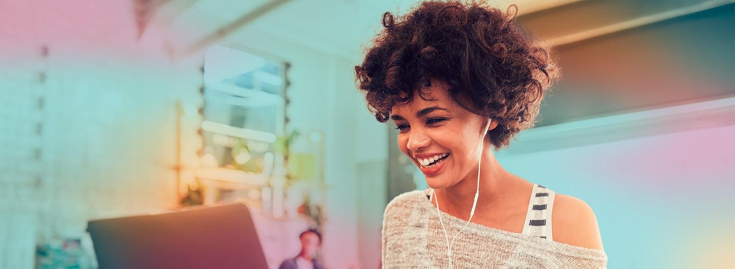 woman_at_home_with_laptop_with_earbuds