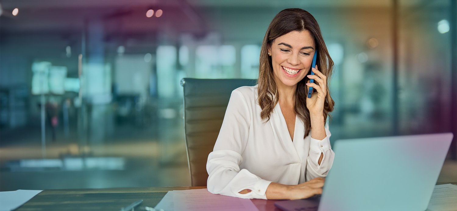 woman_smiling_looking_computer_phone