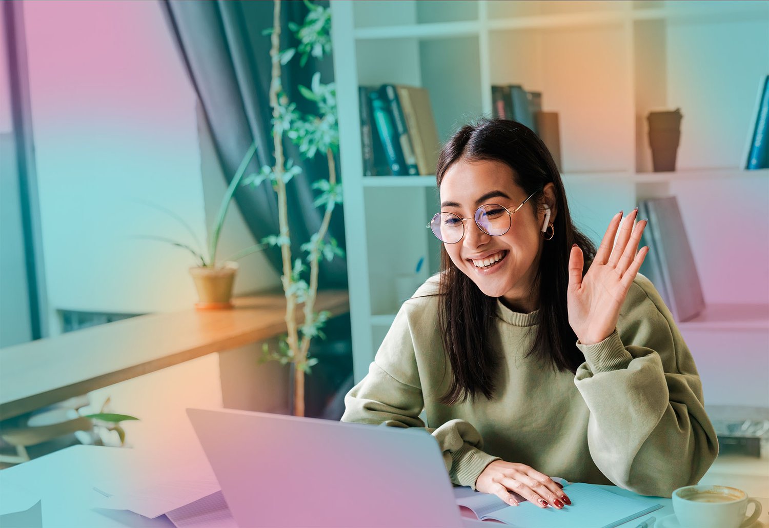 women_at_home_waving_at_laptop